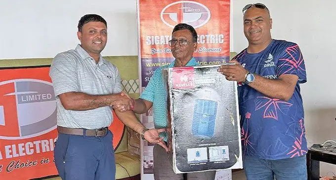 Sigatoka Electric Cooperate Golf amateur title winner Jeral Sharma(left) gets his award from Vijay Narayan.