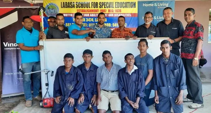Home & Living general manager Ronald Narayan (fourth from the left) handed over three white boards and one brush cutter to Labasa School for Special Education on June 10, 2022. Photo: Supplied  
