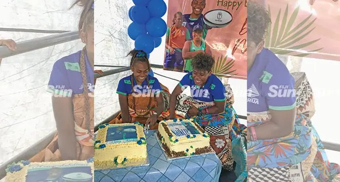 Rooster Chicken Fijiana Drua players, Doreen Narokete (left) and Vitalina Naikore cut their cake during their joint celebration at Milverton Road, Raiwaqa, on May 13, 2022. Photo: Sereana Salalo
