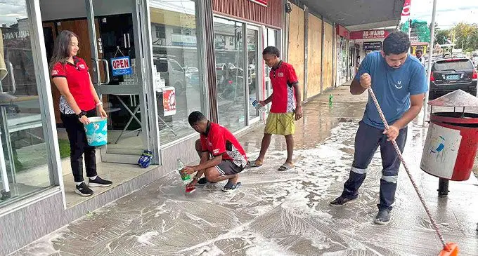 Staff members of Al-Hamd Smart Living cleaning the front of their shop in Nadi on November 7, 2024.