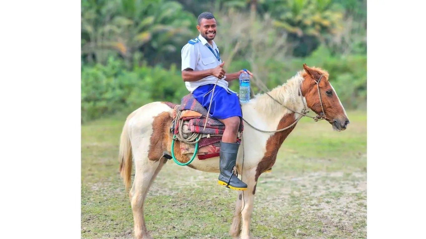 Staff Nurse Degei, 26, on horseback on the outskirts of Wema Village, a remote and terrain area in the Nadroga-Navosa Province. 