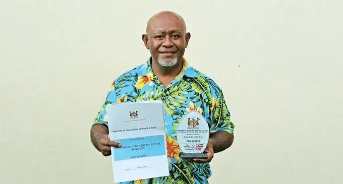 Josua Qalobula holds his certificate and plaque at the retiree event on December 9, 2021 at the Natabua High School. Photo: Salote Qalubau