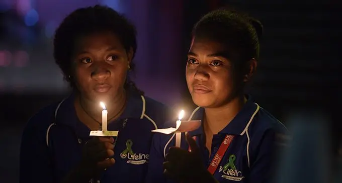 A light of hope ... Lifeline Fiji volunteer Anaette Kula (left) and Freda Johnson during the Lifeline Fiji vigil to mark World Suicide Prevention Day at Terry Walk in Suva on September 10, 2019. Photo: Ronald Kumar