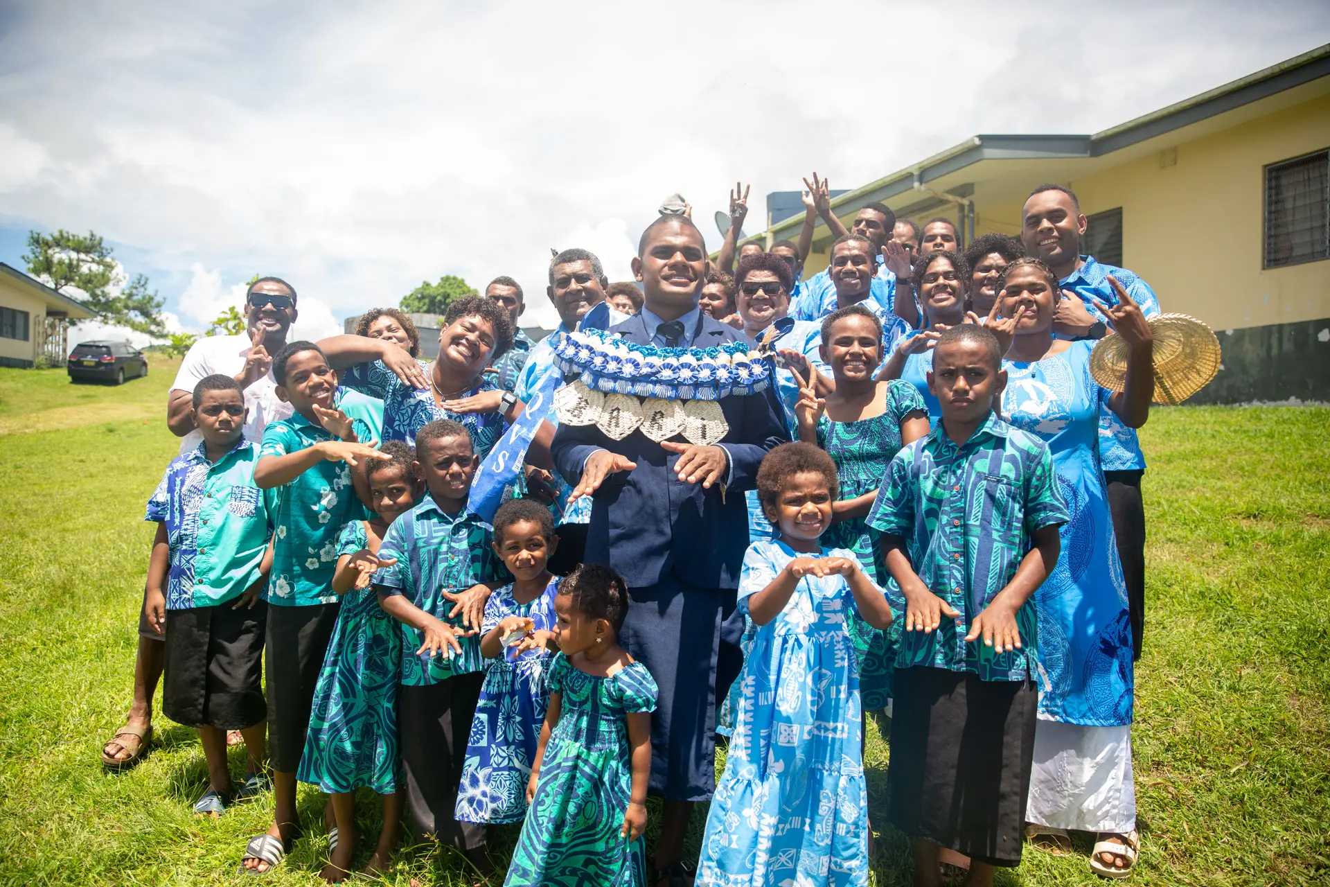 Newly inducted Queen Victoria School (QVS) head  boy Isikeli Bari with family members.