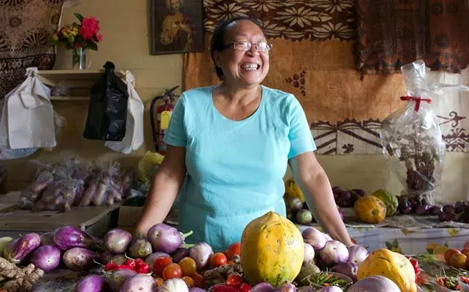 Teresa Yee Show inside the shop where she sells farm produce for market vendors in Levuka.