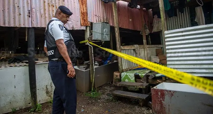 A police officer guards the house in question at Sakoca. Photo: Leon Lord