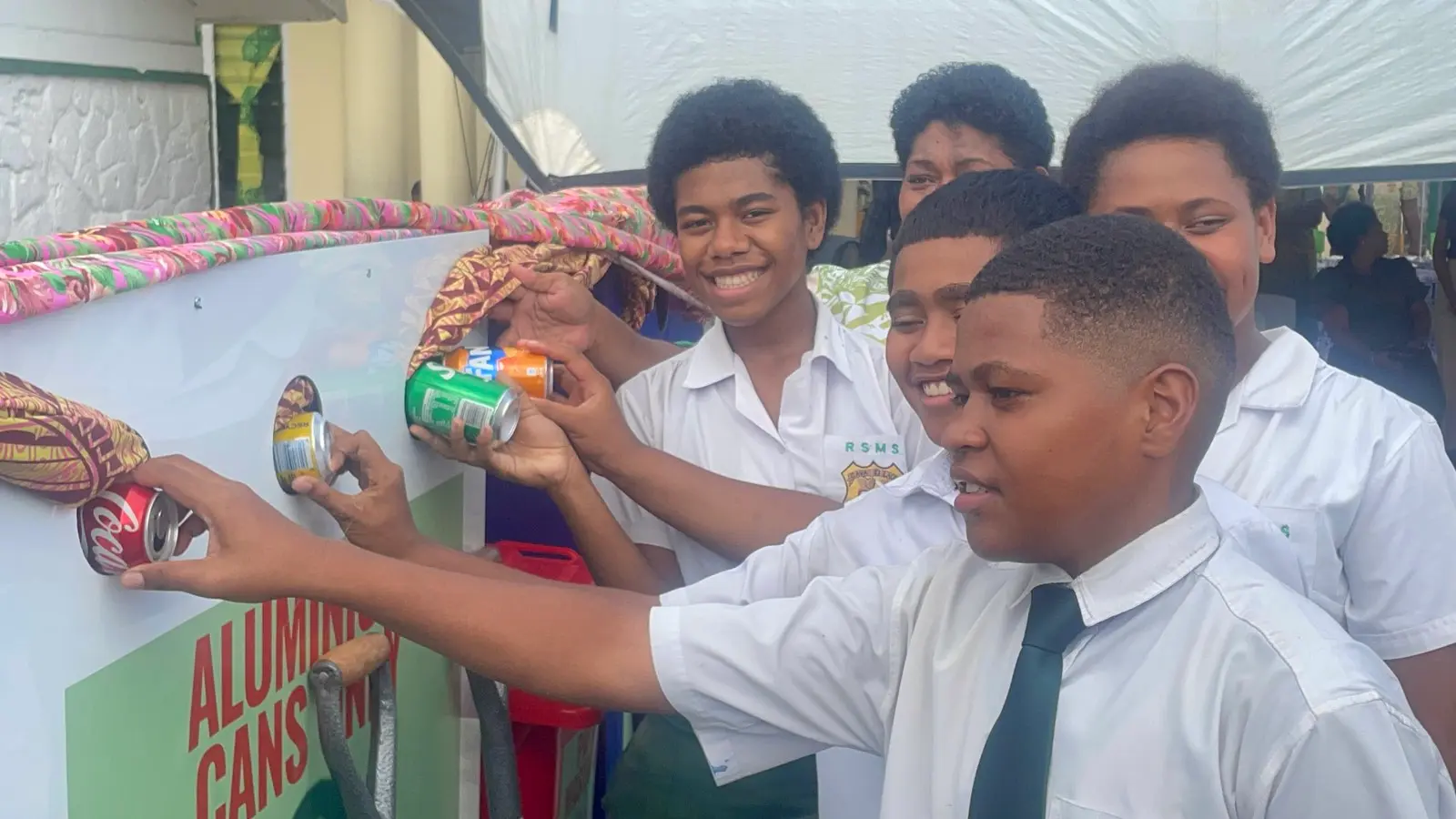 Ratu Sukuna Memorial School students inserting empty cans to the particular bins it belongs too. 