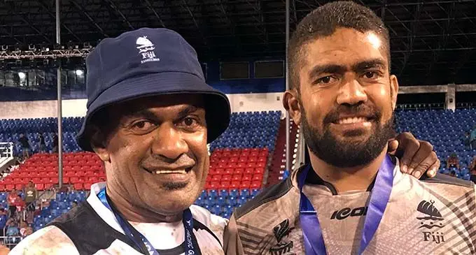 From left: Men’s 9s rugby league coach Vula Dakuitoga with son Maikeli after winning the gold medal at the Pacific Games in Apia, Samoa on July 9, 2019.