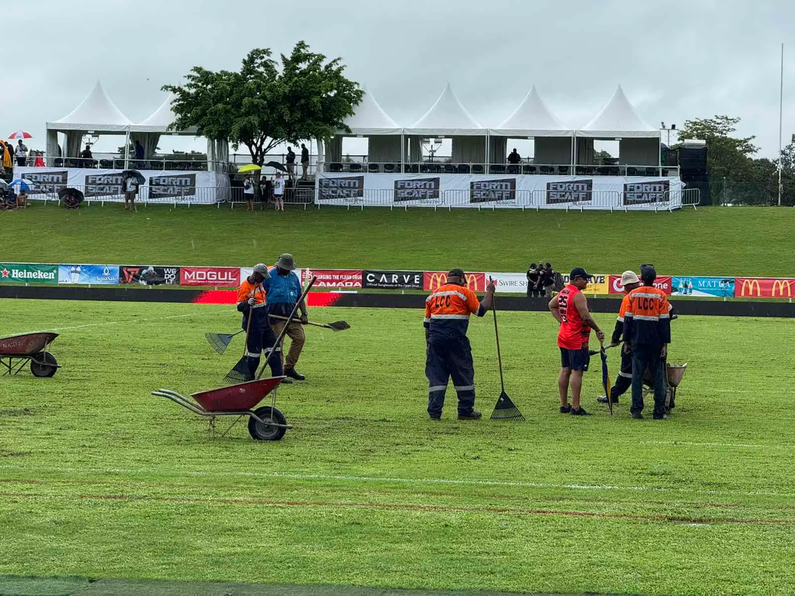 Lautoka City Council employees work on the ground before the Drua and Hurricanes match kick off at 3:35pm