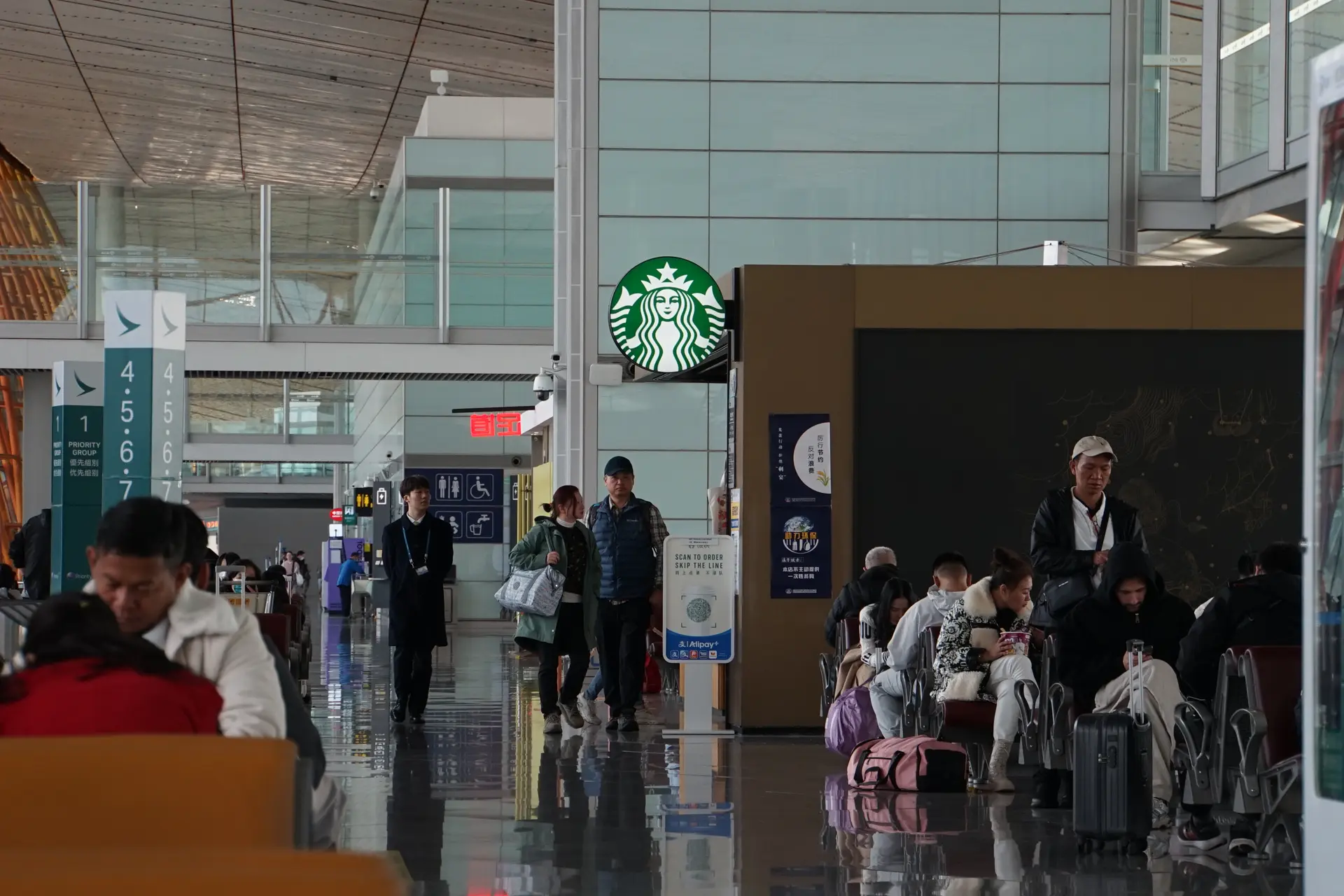 Chinese tourists waiting for their connecting flight to Beijing at the Hong Kong International Airport.