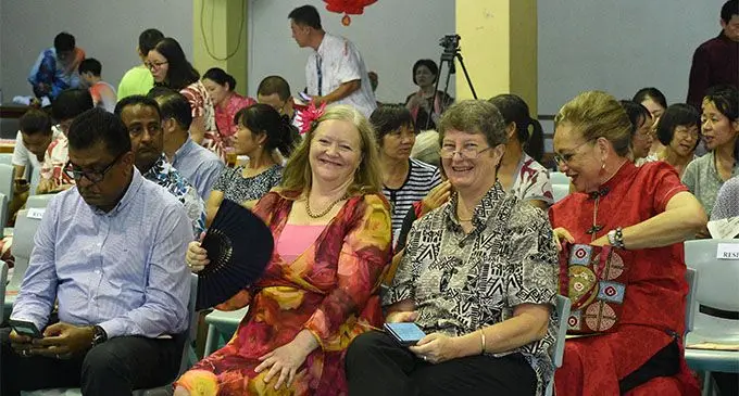 Permanent Secretary for the Civil Service and Acting Permanent Secretary for Forestry Bernadette Welch (with fan) and the Permanent Secretary for Education Alison Burchell at the Chinese New Year Celebration at the Yat Sen Hall in Suva on February 11, 2018.  Photo: Lusiana Tuimaisala