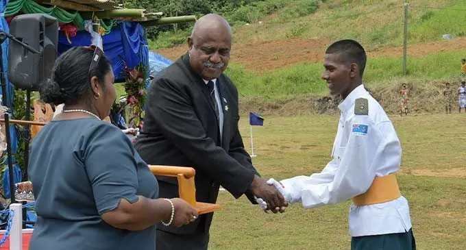 Assistant Minister to the Office of the  Prime Minister, Sakiusa Tubuna congratulates Parade Commander Vinem Narayan with the Baton of Honour award on Tuesday December 12, 2023. Photo: DEPTFO News