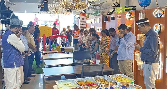Prayers being offered during the opening of Al Hamd Smart Living newest outlet in Tavua. At right is Al Hamd Smart Living Managing Director Ashfaaq Khan.