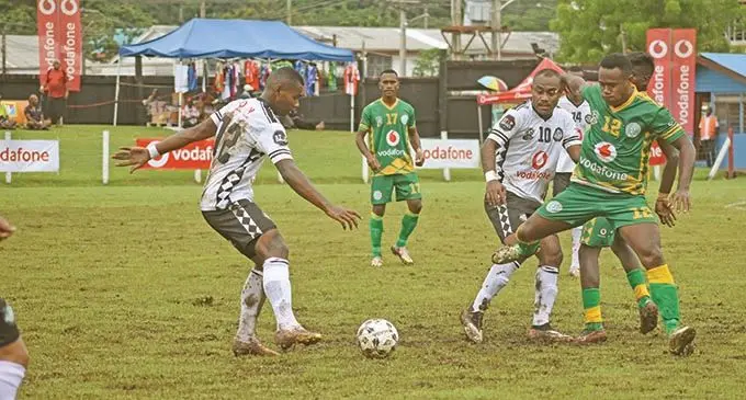 Suva defender Joeli Ranitu tries to pass the ball to Christopher Wasasala as Nadi defender Ame Votoniu comes in with the challenge during the Vodafone Fiji FACT at Subrail Park, Labasa, on November 25, 2020. Photo: Renu Radhika
