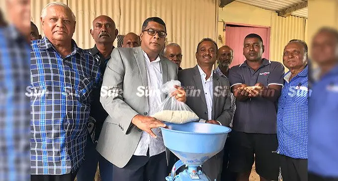 Minister for Agriculture Mahendra Reddy and Assistant Minister for Disaster Management and Rural and Maritime Development Vijay Nath with farmers during the handover yesterday. Photo: Laisa Lui