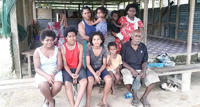 Tori Grey (sitting, right) with his family inside their partially demolished house at the Wainibuabua Settlement in Wainadoi on February 3, 2020. Photo: Inoke Rabonu