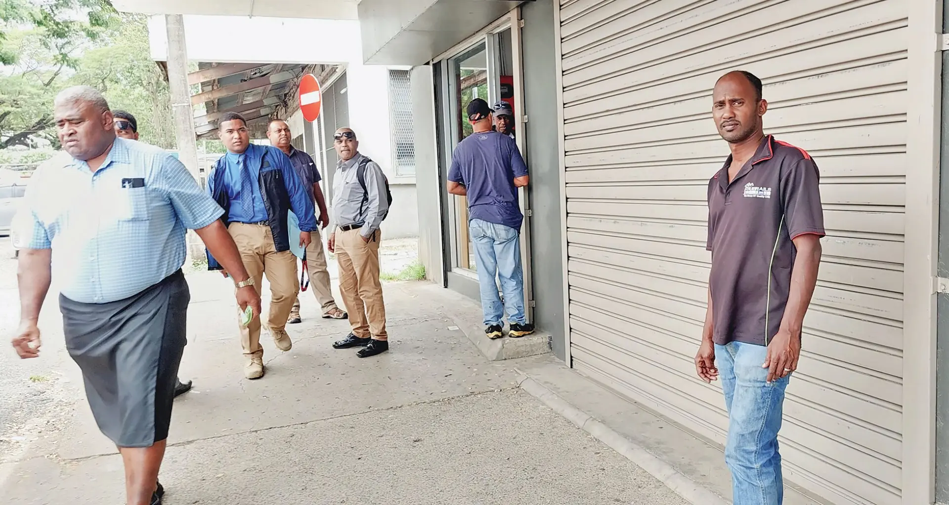 Clearence Shed staff Sachin Kumar (middle) with police infront of the shop at Nede street in Lautoka where the victim was  attacked. Photo: Salote Qalubau
