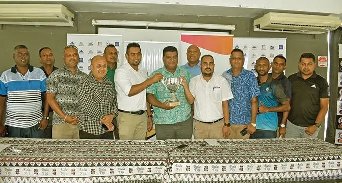 Fiji FA CEO (middle) holds the trophy with RC Manubhai manager marketing, Atish Lal, (left)  and APCO Coatings sales manager, Imraaz Koya, with veteran reps from the districts at the Fiji FA headqusrters, VAtuwaqa on AMrch 2, 2021.  Photo: Fiji FA