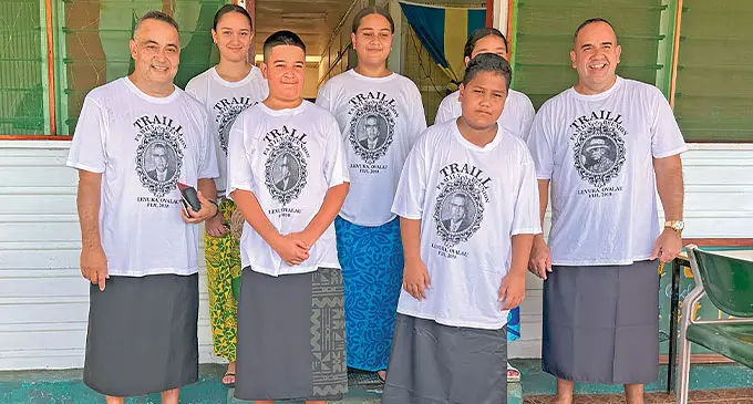 A photo of the Traill family standing in matching shirts.