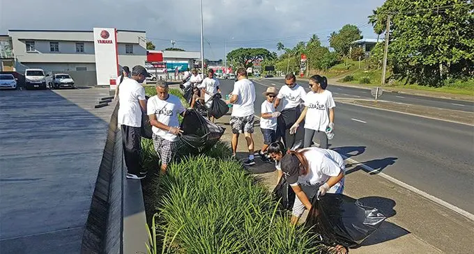 Asco Motors staff cleaning up near their Suva facility.