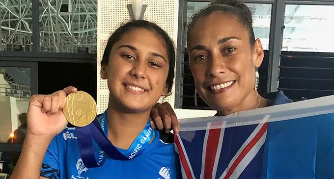 Swimmer Moana Wind (left) shows her gold medal with mum Kay celebrating her win at the Pacific Games in Apia, Samoa on July 11, 2019. Photo: Rosi Doviverata