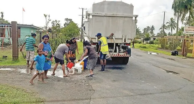 Residents of Nakasi filling their buckets from the water carting truck.