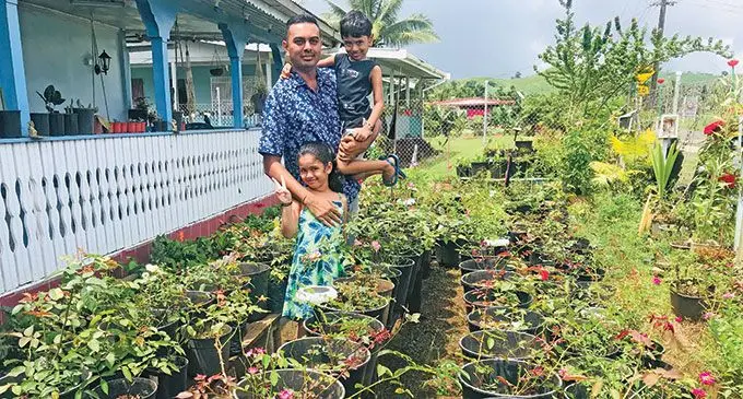 From office to Florist, Rajiv Rajnesh Kumar with his two children, daughter Myra and son Myrav Kumar at the flower bed in front of their home in Wailevu, Labasa on March 3, 2022.Photo: Laisa Lui.