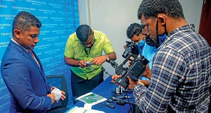 The Supervisor of Elections Mohammed Saneem, showing the Nationwide Voter Registration and Awareness Drive schedule to the members of the media. Photo: Fijian Elections Office