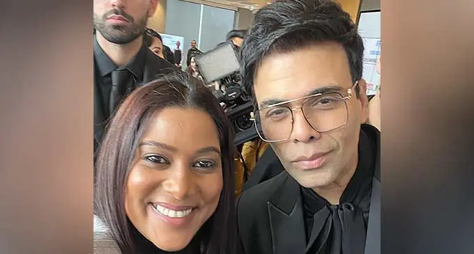 Anita Prasad with Indian film maker Karan Johar.