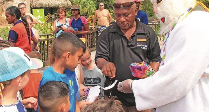 Easter bunny and a staff of Radisson Blu hand out Easter eggs to children staying at the resort.