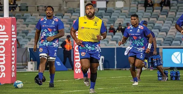 Swire Shipping Fijian Drua loosehead prop Haereiti Hetet (yellow vest) warming up with teammates Te Ahiwaru Cirikidaveta (left) and Zuriel Togiatama at the GIO Stadium in Canberra, Australia, on April 14, 2023. Photo: Leon Lord