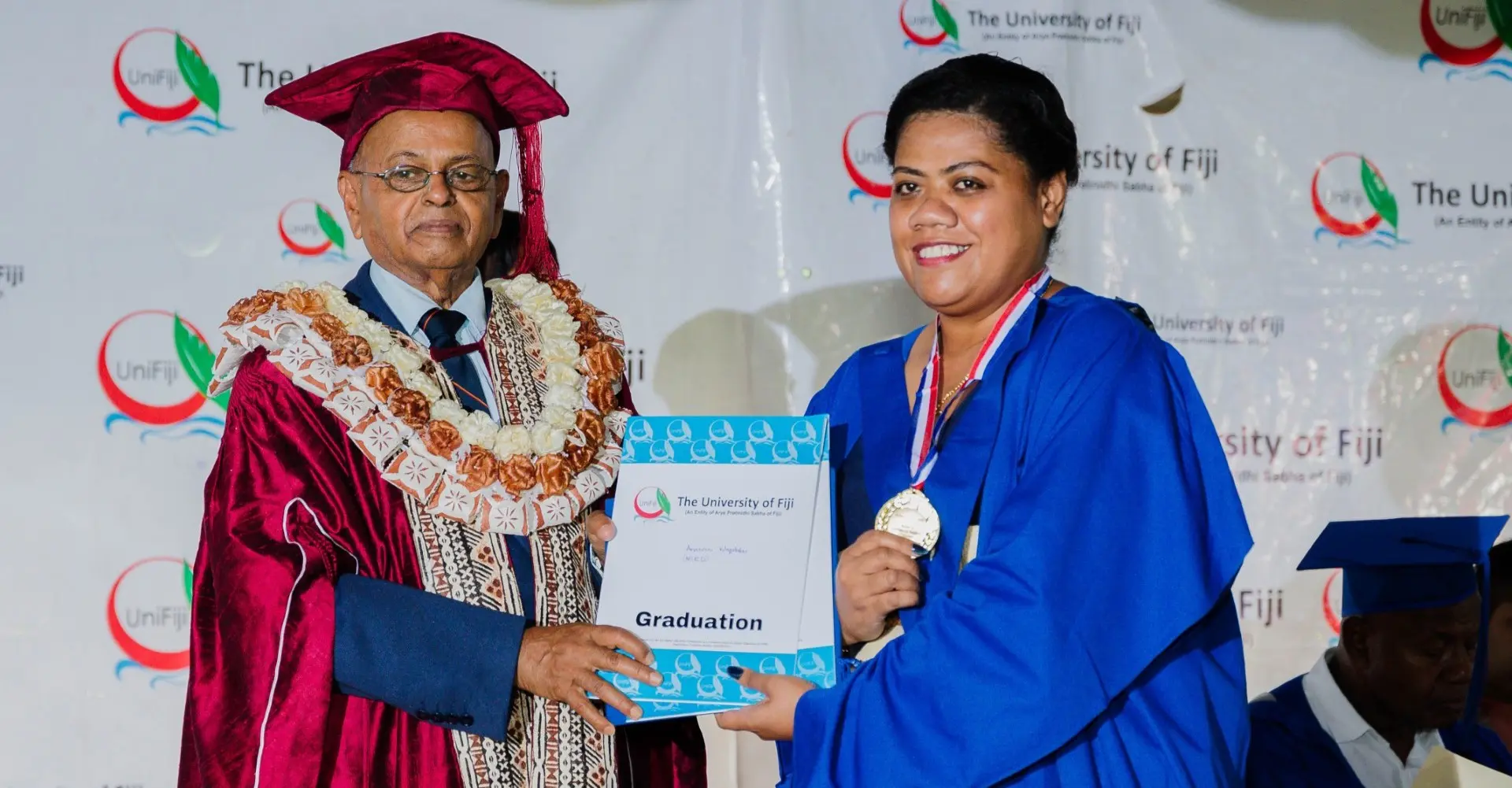 Anaseini Waqatabu receives her award from University Pro-Chancellor Pundit Bhuwan Dutt.