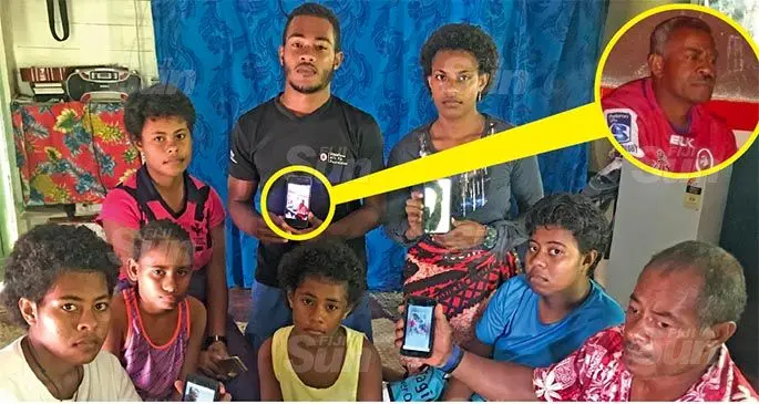 Jekope Matanamatua (lower right) cousin of the deceased with the family members showing photos of the late Baleyaganiga Village headman Amoritikei Mainalulu (inset) at Vunivau in Labasa on April 17, 2020. Photo: Shratika Naidu