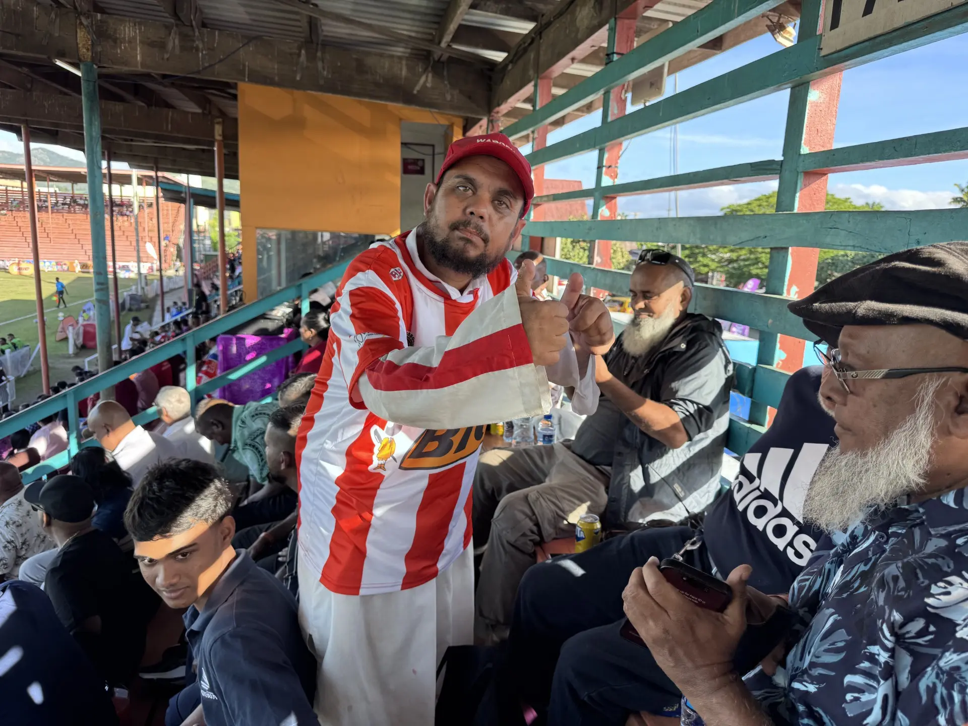 Football fan Mohammed Izaz (red shirt) sells snacks to fans at Subrail Park, Labasa, on June 19, 2026.