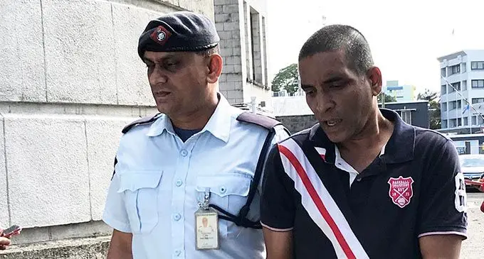 Sanjay Lakhna is escorted by a Police officer at the Suva courthouse on July 13, 2020.  Photo: Ashna Kumar