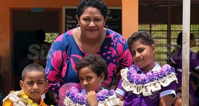 Mum, Imeri Koroivutagi with her children after being badged prefects at Chauhan Memorial School.
