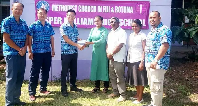 From left: representatives of CCCC First Harbor Consultants Ba Te, Ao Lei, general manager Liu Hongguaug handing over the cheque to Jasper Williams High School principal Vanita Sharma Kumar, vice-principal Ranjit Prasad, Assistant Principal Sneh Lata and Parents, Teachers and Friends Association resident Donald Singh at Jasper Williams High School on February 27, 2019. Photo: Rohit Kumar
