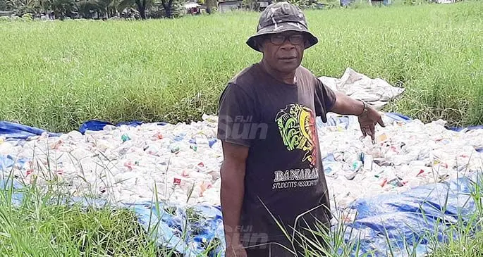 Manueli Sovau points at the bulk of bottles collected by residents of the California Lovu Settlement to sell in Lautoka. Photo: Salote Qalubau