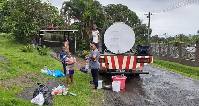 Residents in Samabula refill their buckets and bottles from a water truck as water cuts still plague the area.  Photo: Shalveen Chand