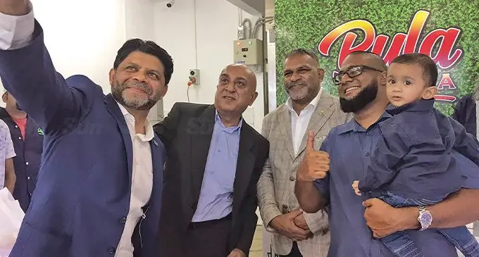 From left: Chairman of Special Administrator Nausori/Nasinu Uma Kant Patel, Minister for Commerce,Trade, Tourism and Transport Faiyaz Koya and Abbus Quality Halal Meats director Asad Ali carrying his son on August 5,2022. Photo: Laisa Lui