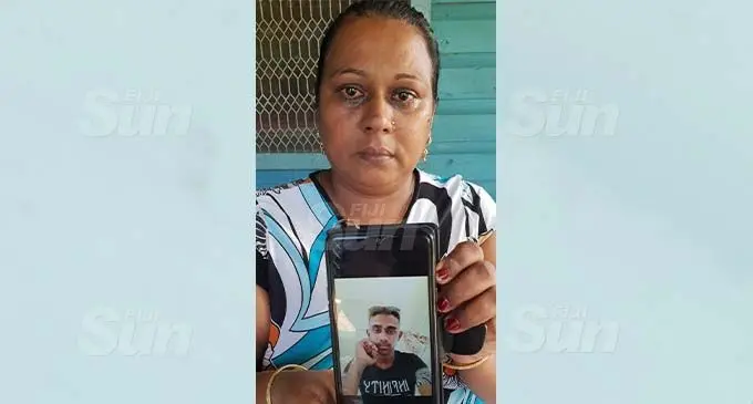 Anjina Devi holds a photo of her son, Hasneel Sharma outside her home in Velovelo, Lautoka. Photo: Nicolette Chambers