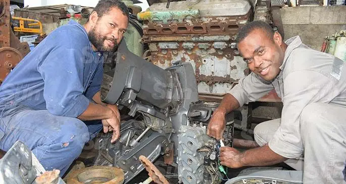 From left: Former national sevens team winger Isikeli Vuruna and former Flying Fijians halfback Aporosa Kenatale work on an outboard engine at Stanley Brown Naval Base in Walu Bay, Suva, on May 19, 2020. Photo: Ronald Kumar.