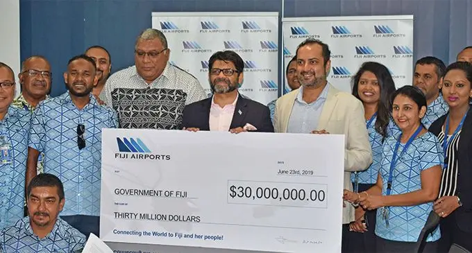 Attorney-General Aiyaz Sayed-Khaiyum receives dividend cheque from Fiji Airports board member Ratu Wiliame Katonivere and Acting CEO Faiz Khan with staff at the Fiji Airports Limited HQ in Namaka. Photo: WAISEA NASOKIA
