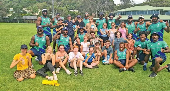 Swire Shipping Fijian Drua players with children whose families were evacuated from the Lismore flooding and are sheltered at Lennox Head on March 9, 2022. Photo: Fijian Drua.