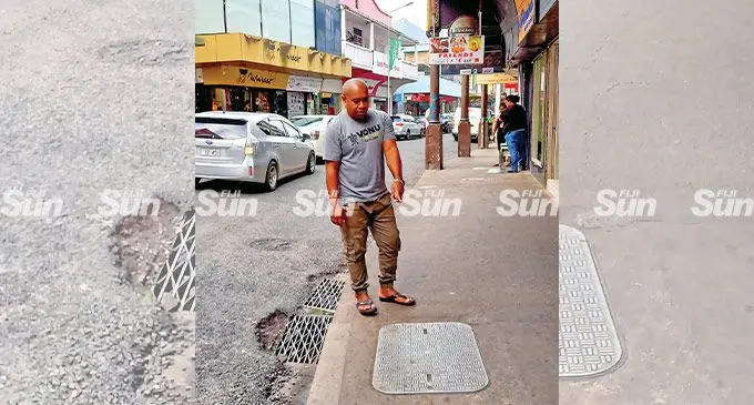 Vili Bukateci at one of the manholes along Cumming St. Photo: Ronald Kumarat