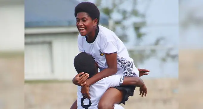 Sisilia Kuladina (9) celebrates with captain Annie Finau (5) after scoring a goal against Cook Islands. Photo: Fiji Football Association