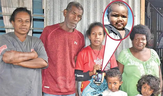From left: Paulini Davila, grandfather Seremaia Vesikula, the late Seremaia Vesikula’s mother Iliseva Tinai (displaying a picture of Seremaia in happier days), grandmother Tinai Vesikula. (Front:) Kalesita Cokanasiga and Kiran Wati at Nawaicoba in Nadi. INSET: Seremaia Vesikula in happier days. Photo: Mereleki Nai