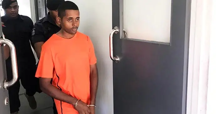 Amitesh Kumar escorted by a Police officer  outside the Magistrates Court on October 1, 2019.  Photo: Ilaijia Ravuwai
