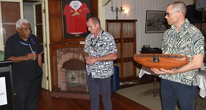 From left: Fijian Media Association president and Fiji Sun Managing Editor Training Nemani Delaibatiki, Australian High Commissioner, John Feakes and Alex Park during the lali presentation at a dinner at the High  Commissioner’s residence in Suva on July 16, 2019. Photo: Australian High Commission   