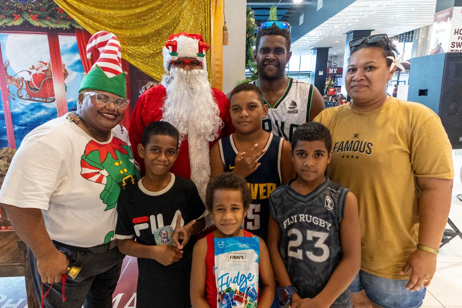 From left: Lusia Maria dressed as an elf, Semi Seru as Santa Claus, John Baleicakau and his wife Vuli Soqoiwasa with their children Vilima Ralawa (8), Sakiusa Matailevuka (10), Sunia Qalobula (9) and Lia Veiqaravi (7) during a family Christmas outing at TappooCity, Suva, on December 23, 2025.
